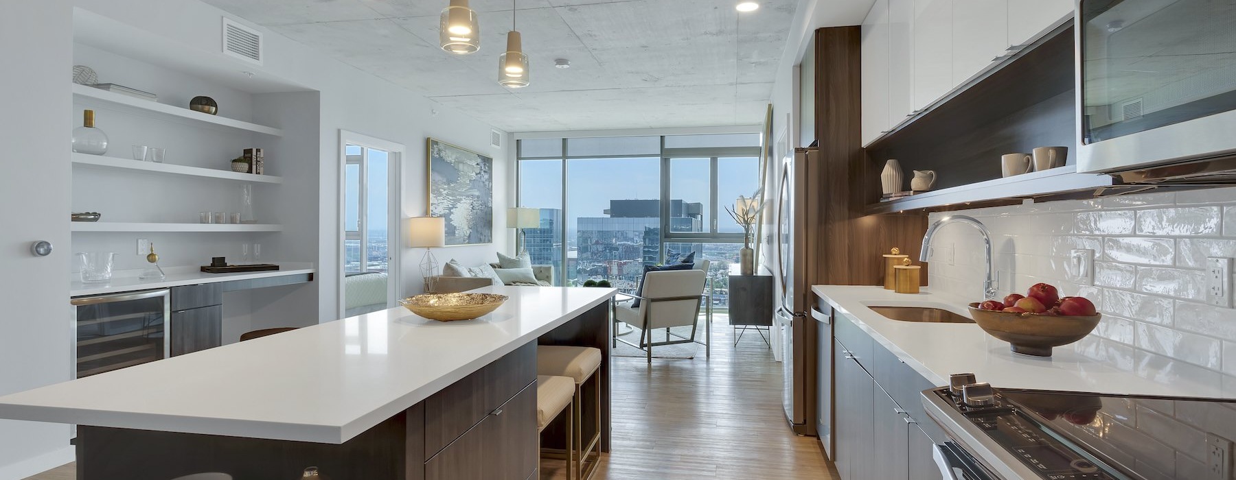 a kitchen with a large island and stainless steel appliances